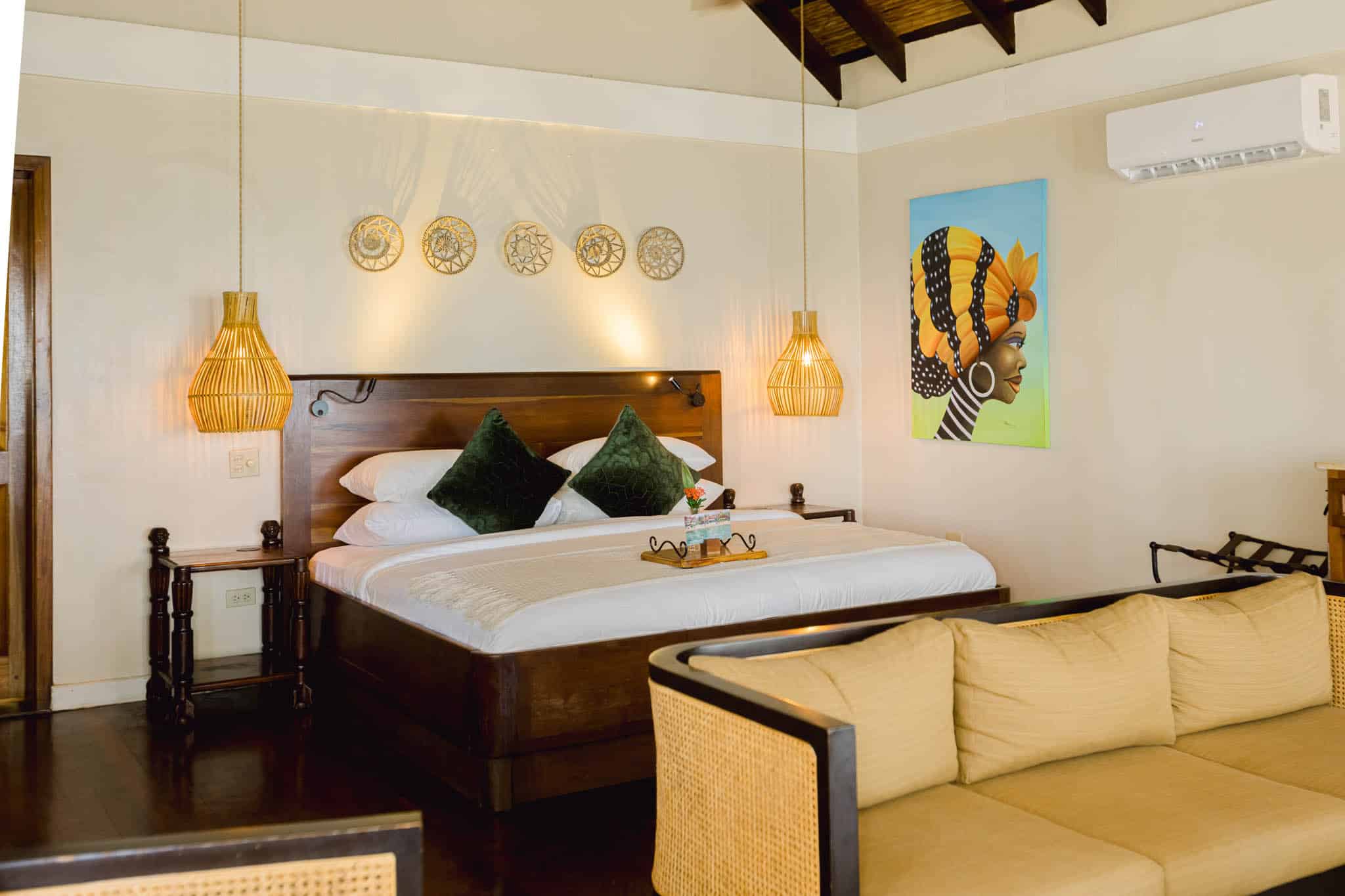 Charming and intimately appointed Beachfront Cottage bedroom with Caribbean coastal ambiance at The Resort at Almond Beach, Hopkins, Southern Belize